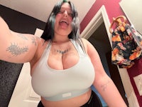 a woman with tattoos taking a selfie