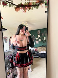 a woman is taking a selfie in a mirror